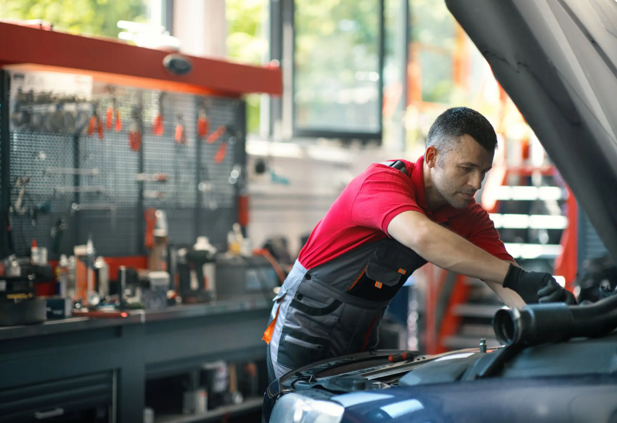 Mechanic working on a car engine.