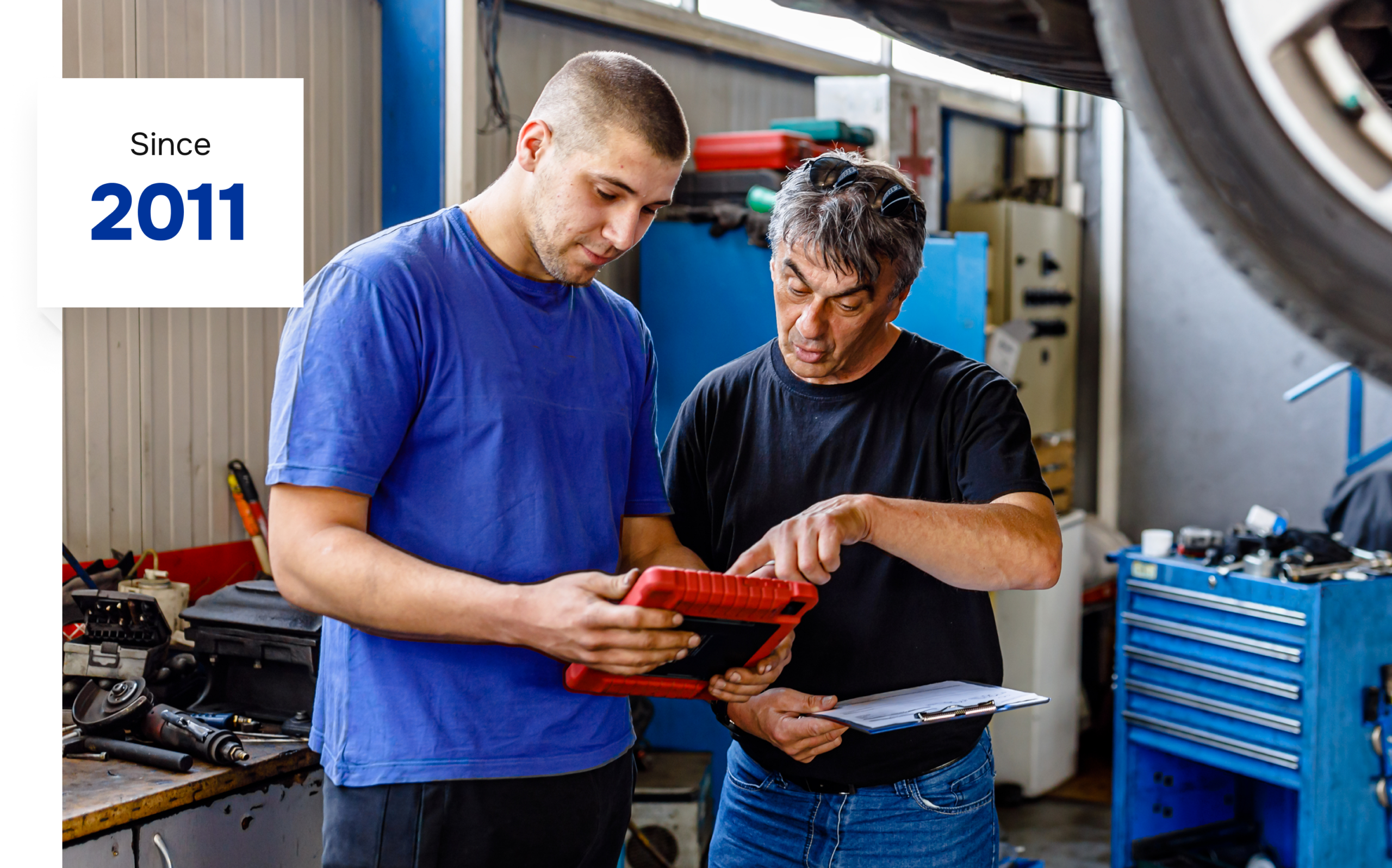 Two mechanics discussing car diagnostics.