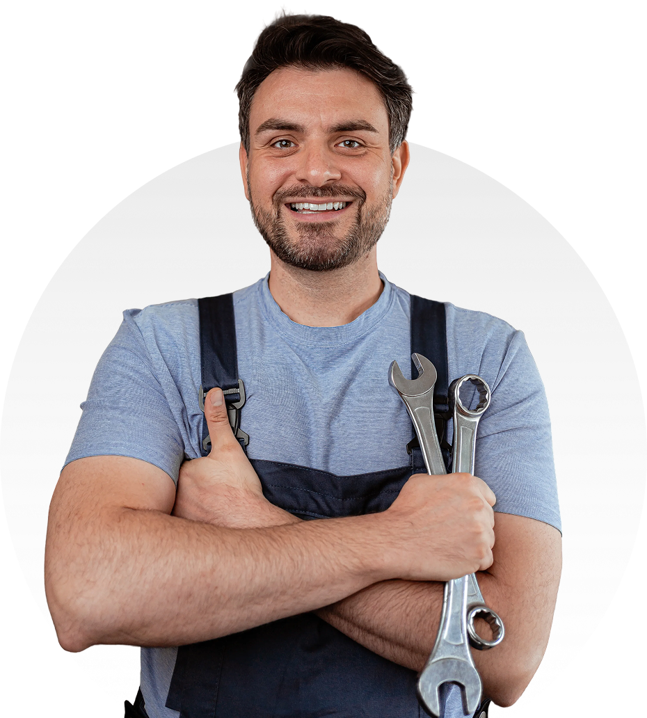 Smiling mechanic holding wrenches, gray background.