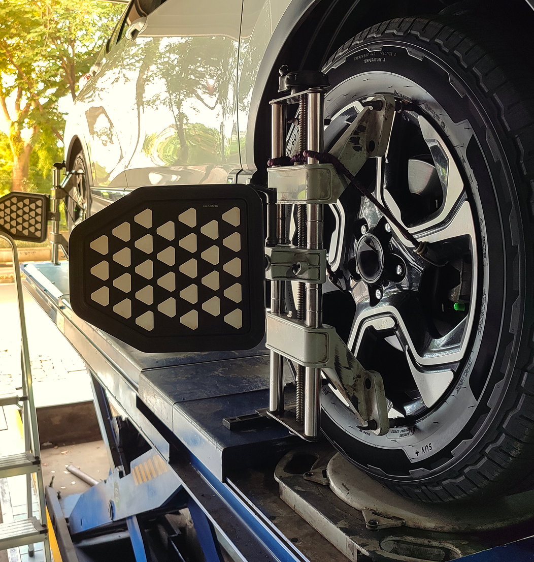 Car wheel alignment on service lift.
